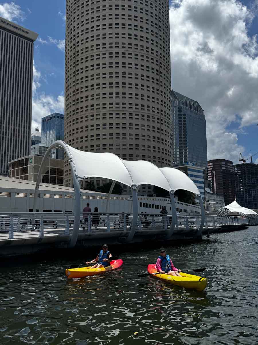 Two people in two kayaks in the river in downtown Tampa, one of the fun things to do in Tampa Bay