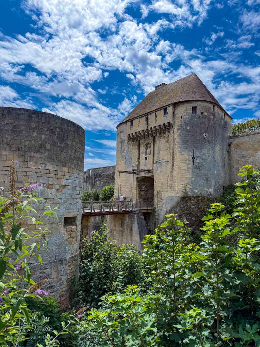 A fortress turret and gate with a drawbridge connecting the two at the entrance of Caen Castle in France